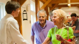 Rector greeting parishioners after service